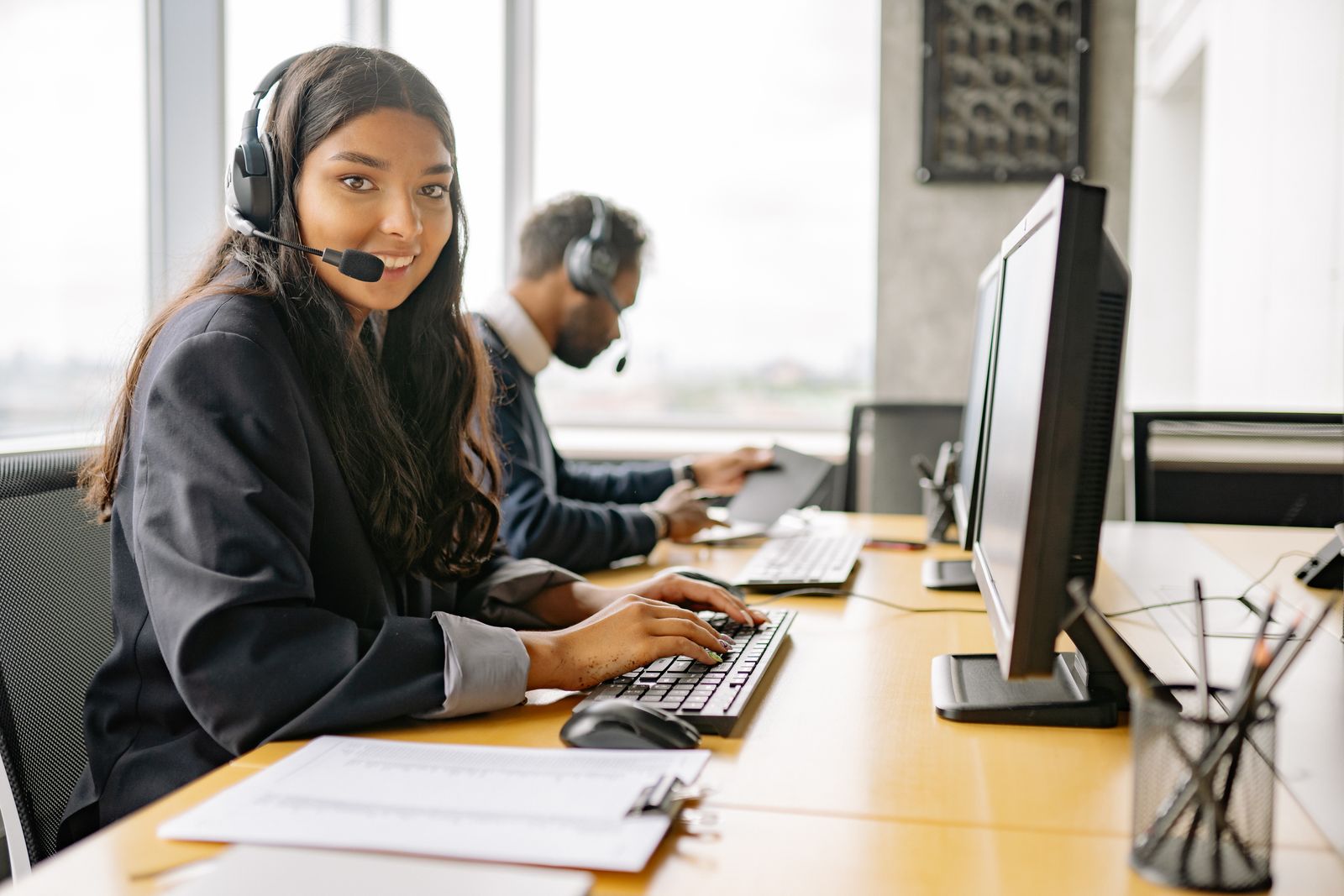 Support representatives assisting customers at a desk