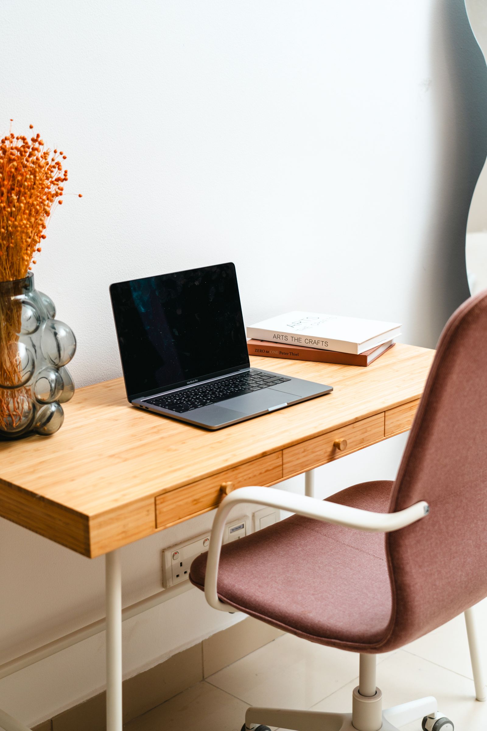 Bright home office with a laptop on a wooden desk