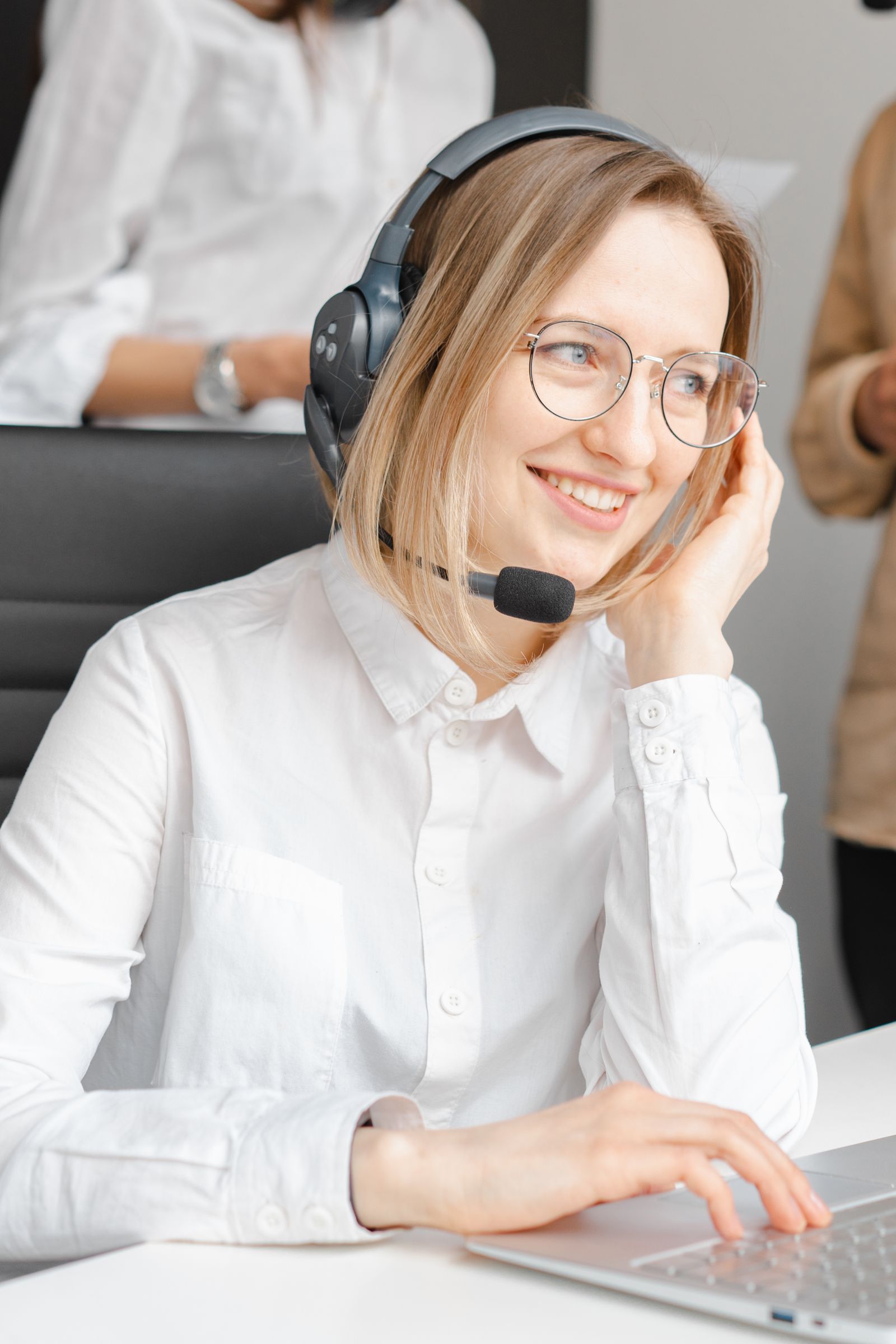 Support representative at a desk wearing a headset